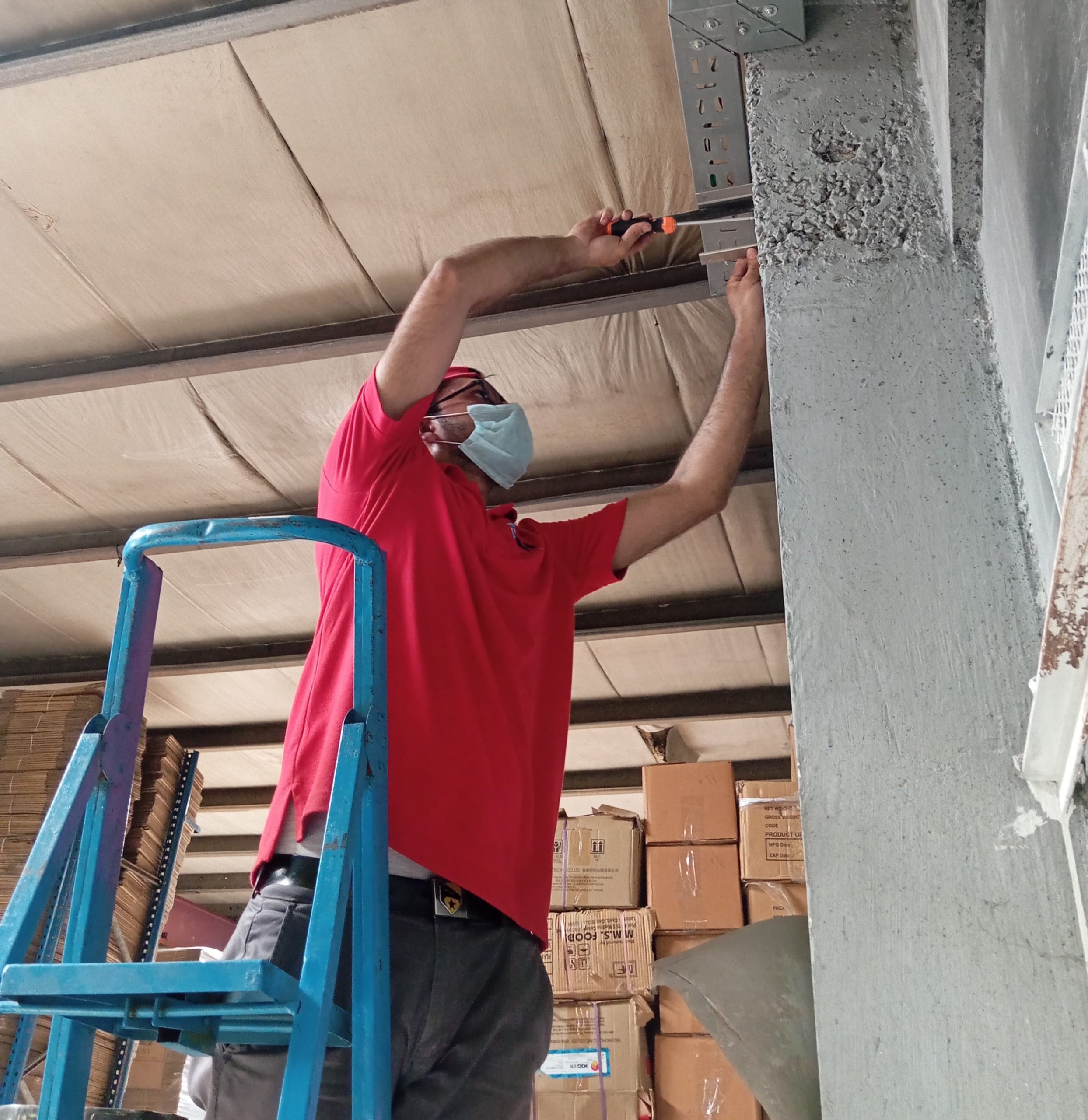 Israintech team installing CCTV cable tray and mounting brackets on site in Lahore
