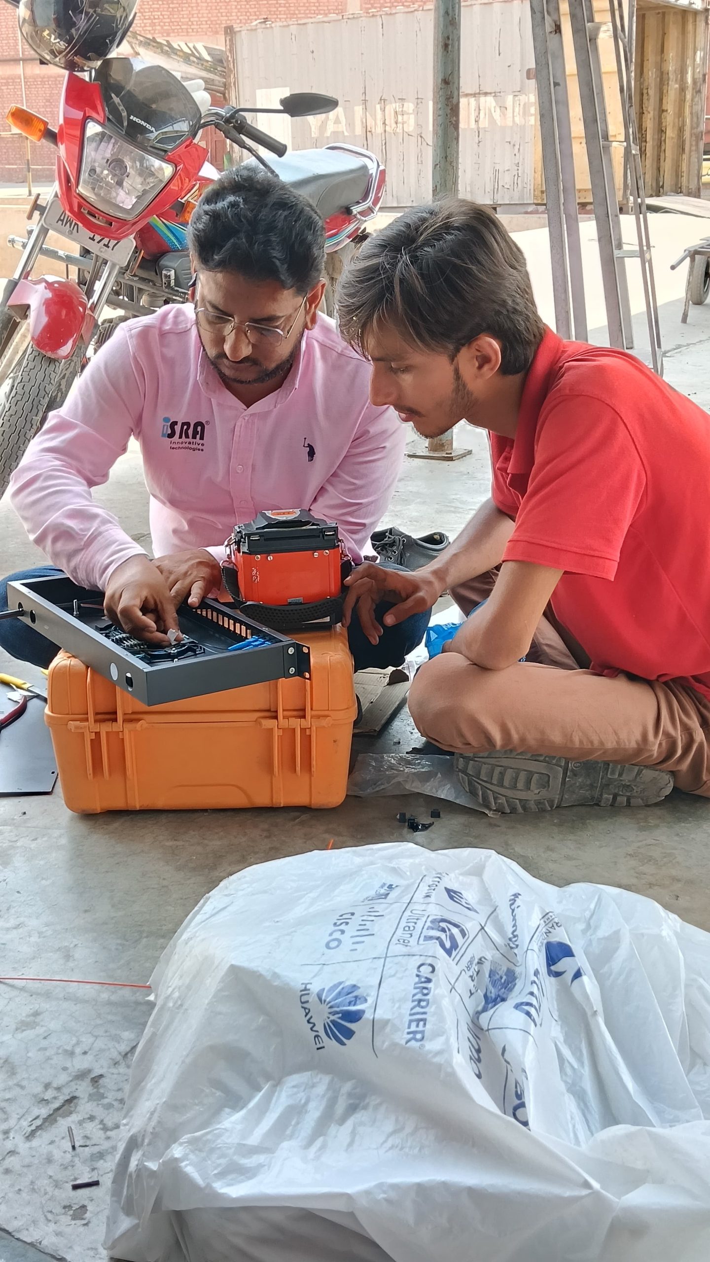 Israintech technical team preparing network equipment for a CCTV installation in Lahore