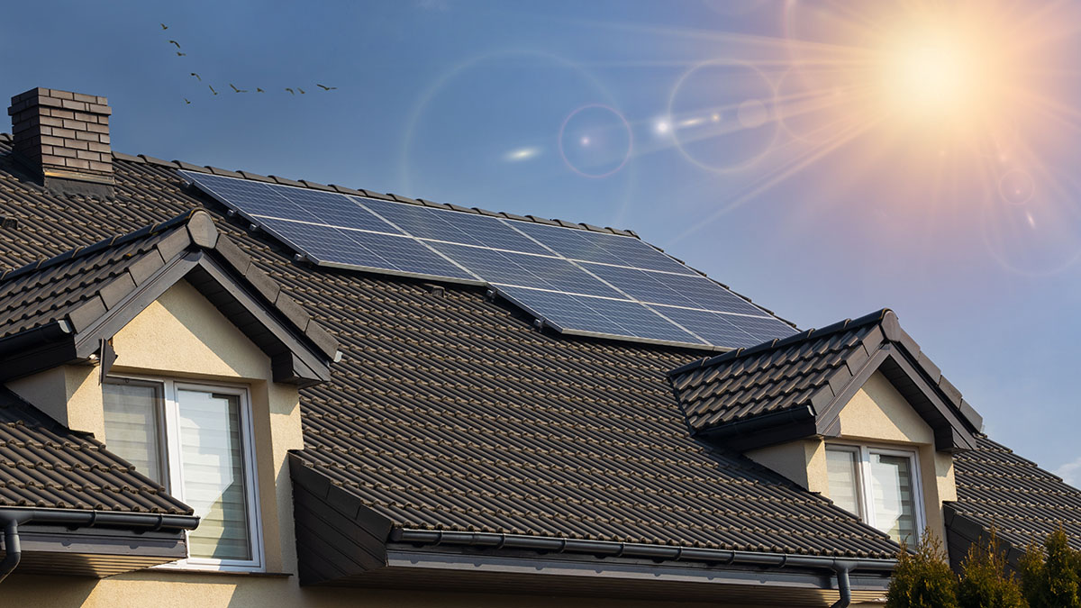 Residential rooftop solar panel installation under clear sky